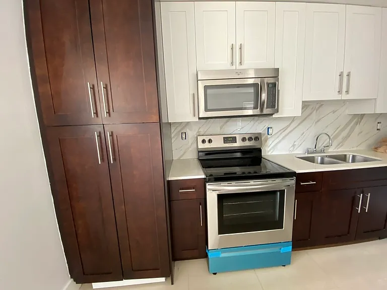 kitchen with washer dryer in cabinet