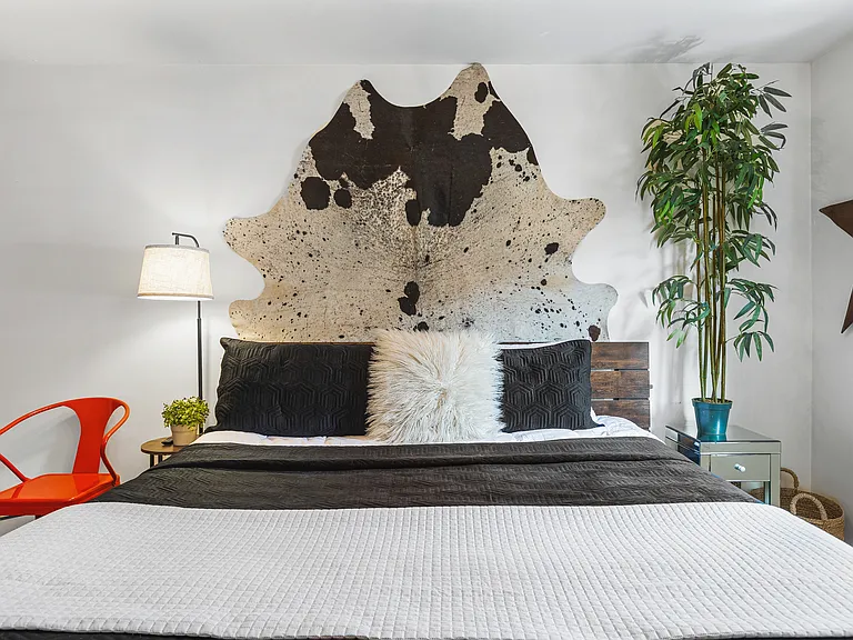 Comfortable King bed in the bedroom. Includes a smart TV, desk to get ready at, dresser and a closet to store your items in.