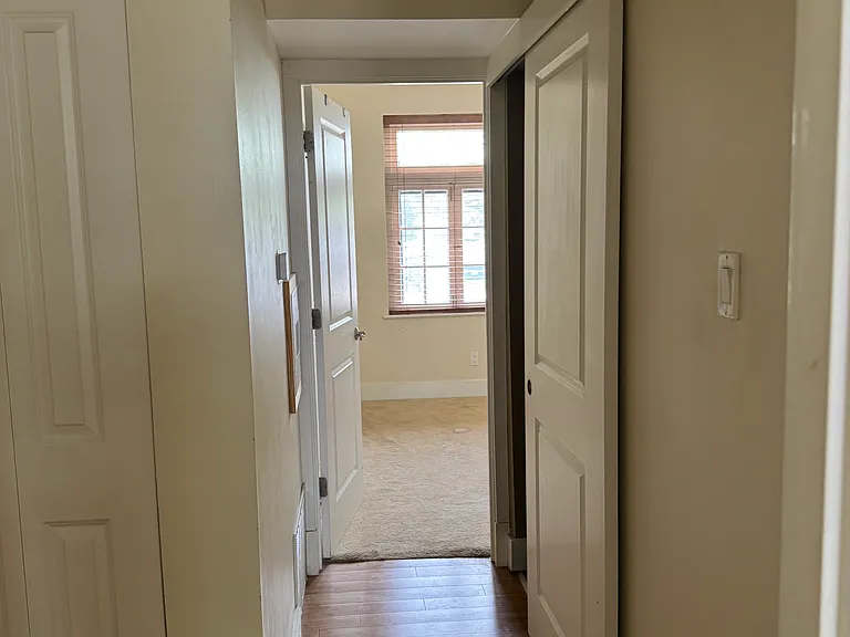 Hallway connecting bedrooms and bathroom.