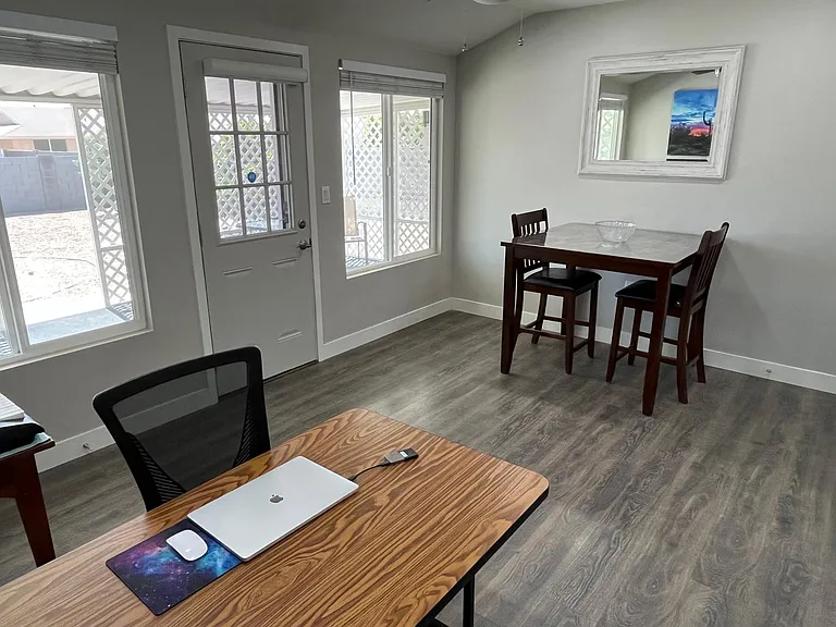 This is an office/Arizona Room off the garage. It's open to the dining area, the TV end of the living room, and the kitchen.