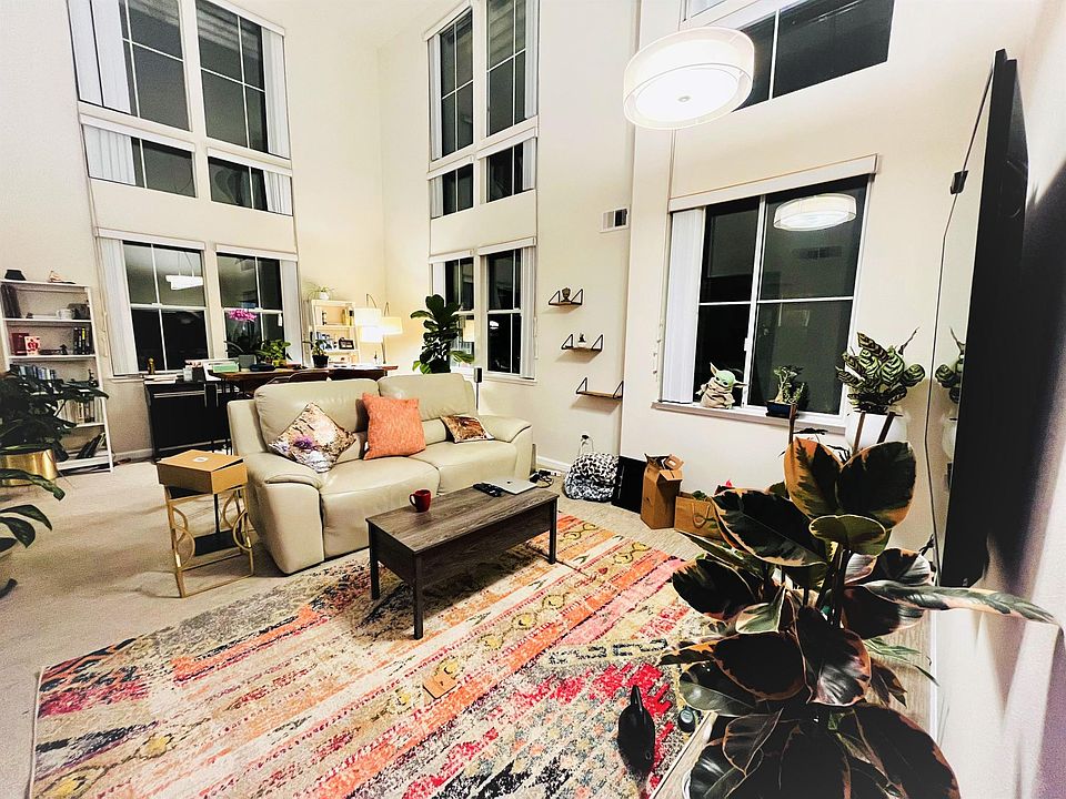 Spacious living room area with a high ceiling that makes it look even bigger!