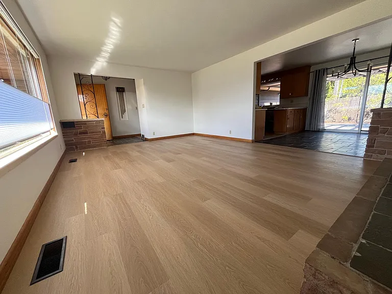 Living room with brand new flooring and top-down, bottom up cellular shades on front picture windows.