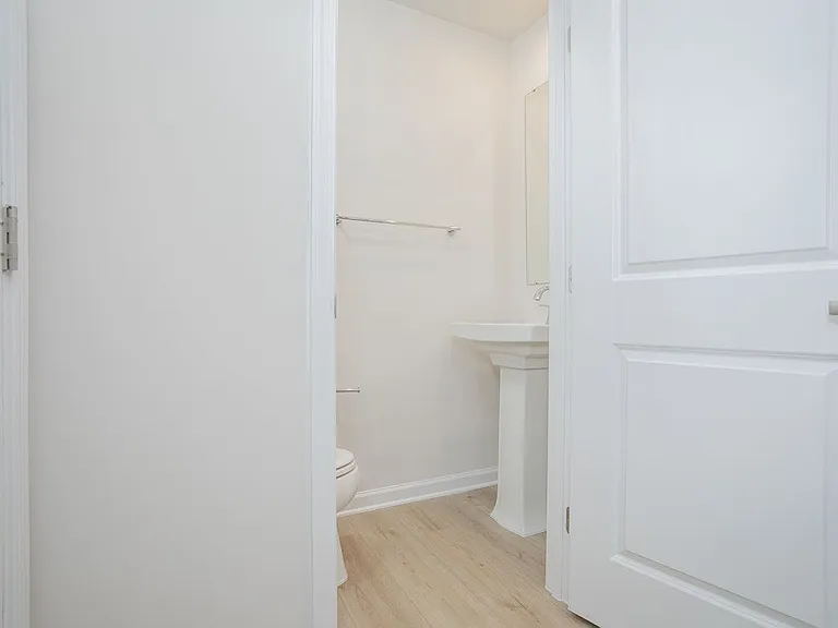 Tucked in the entry way is a half bath with pedestal sink