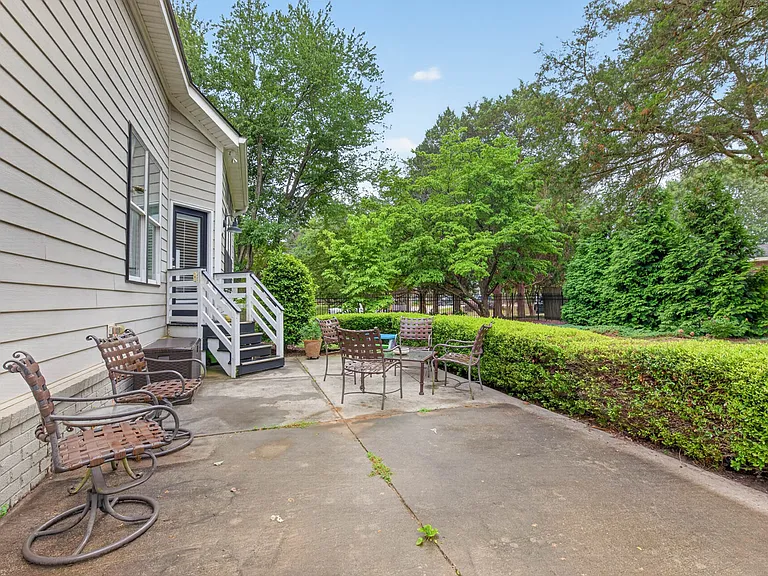 Manicured landscaping, fenced in backyard and large concrete patio