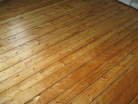 Refinished wide pine in upstairs bedroom