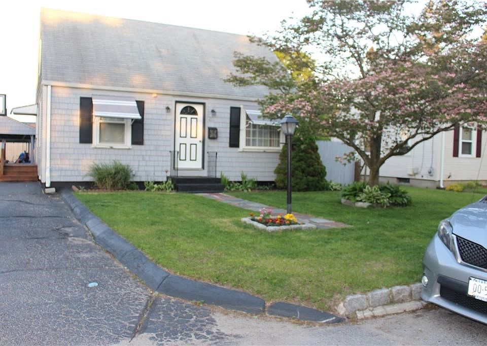Front of house with beautiful magnolia tree and flagstone walk.