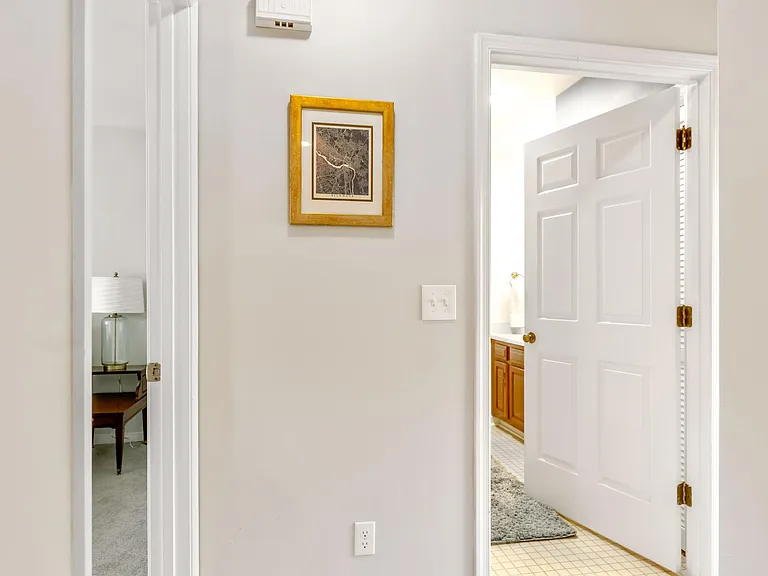 Hallway to full bathroom and bedroom.