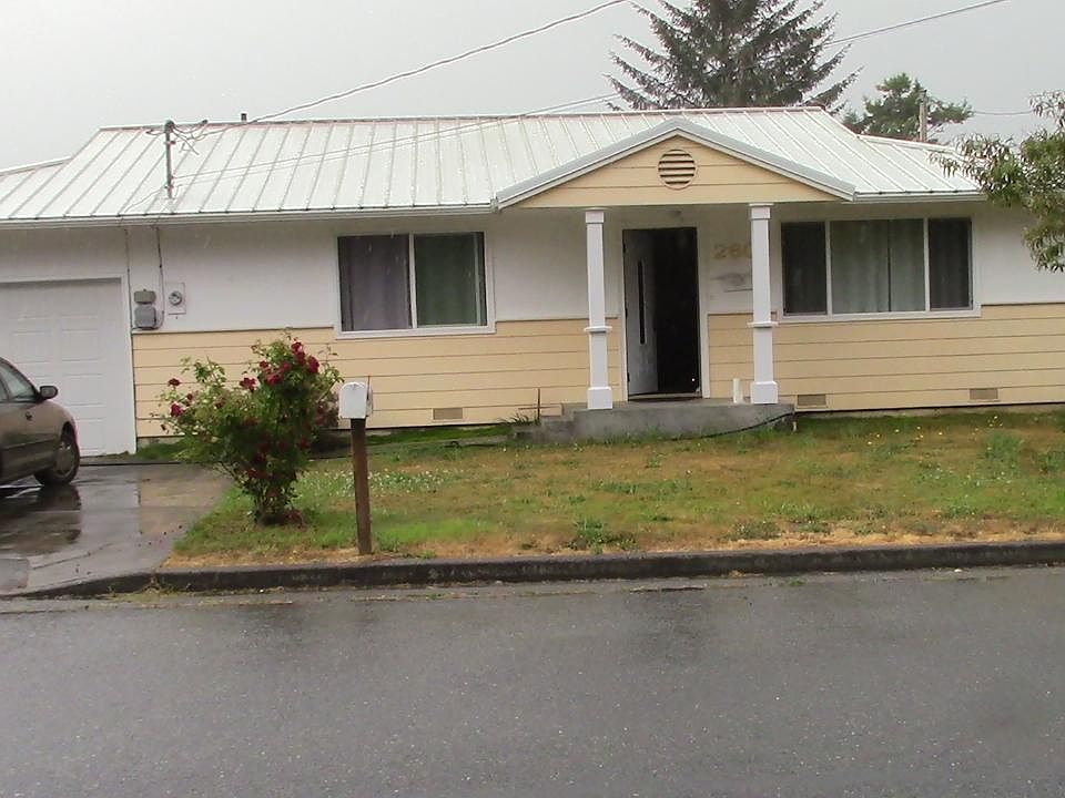 Front of house with big entry porch, plenty of parking, new metal roof, home mail delivery.