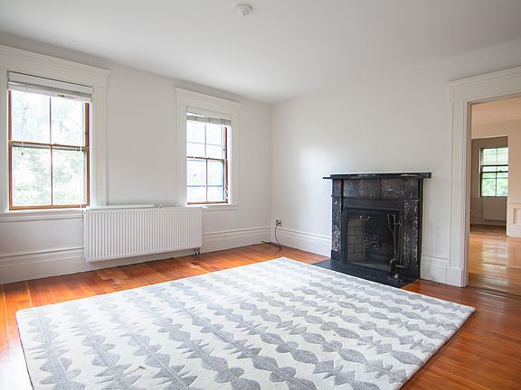 Living room w/ original 19th century marble fireplace