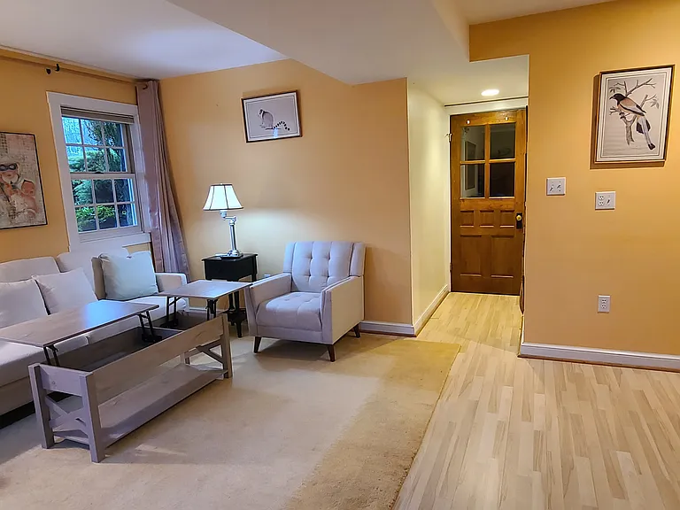 Convertible coffee table extends for light meals or computer work. Hallway leading to bathroom and bedroom.