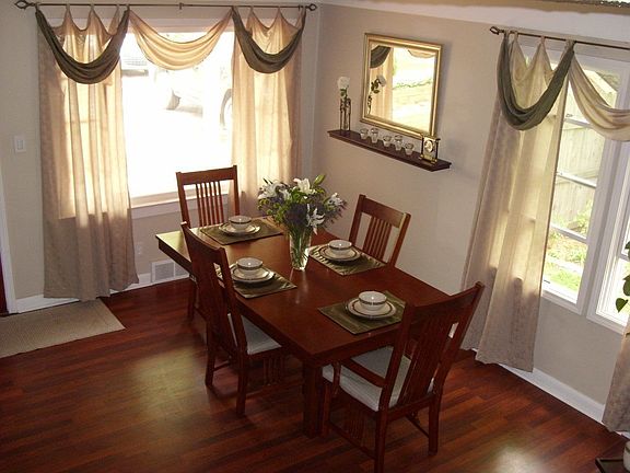 Dining/Living room with bright windows, wood flooring