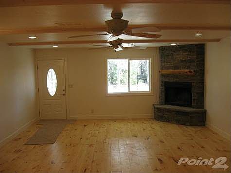 living room with brand new stacked stone fireplace