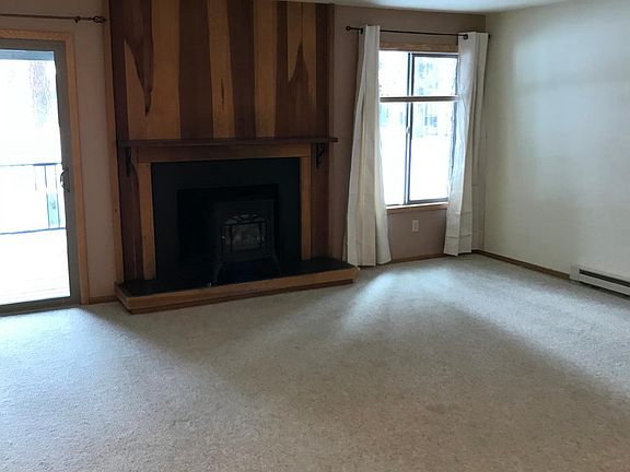 Large open living area with vermont casting electric stove