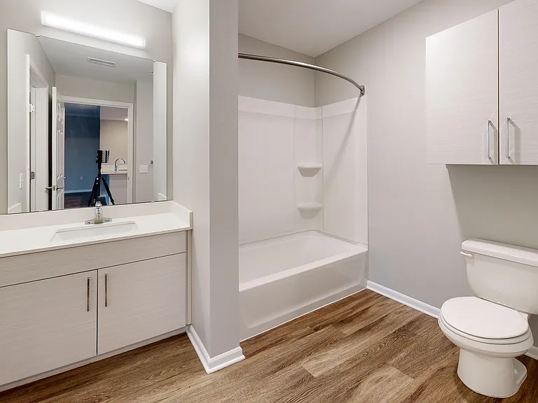 The Redbud's shared bathroom has two entries _ one from the shared living space and one with direct access from the primary bedroom. The Redbud's shared bathroom has two entries _ one from the shared living space and one with direct access from the primar