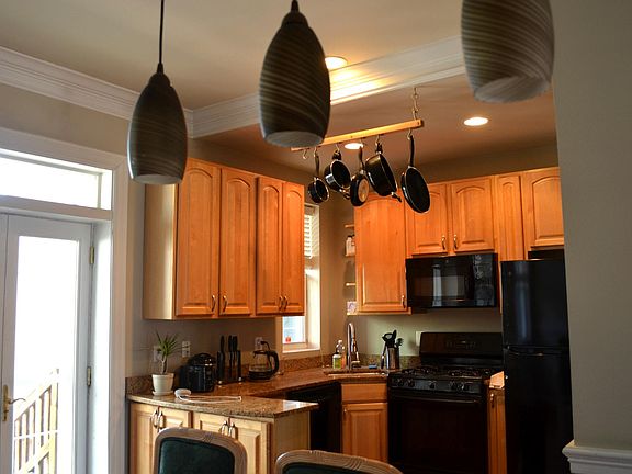 Kitchen: refrigerator, microwave, stove top, kitchen cart