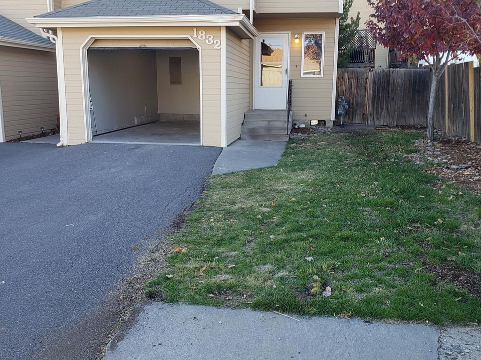 Front view of townhouse with garage door open. Road view of Johnson AVE.
