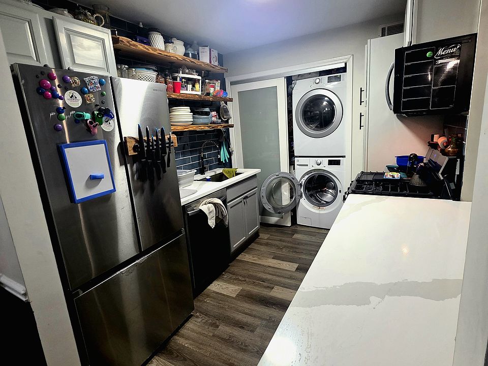 Kitchen. Sliding door has washer/dryer on the right side and pantry on the left side.
