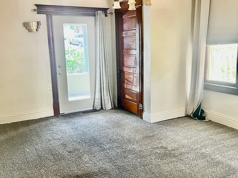 Other angle of Bedroom 1 facing porch walkout door and closet