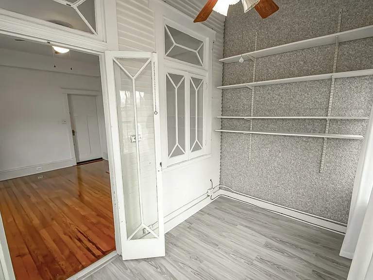 Solarium off main bedroom upstairs, front of home, wall shelving.