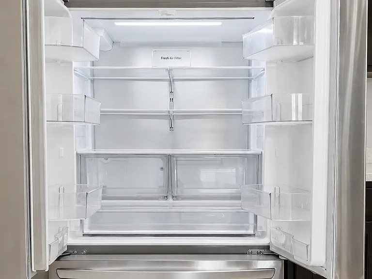 LG double-door refrigerator and pull-open freezer with an automatic ice maker.