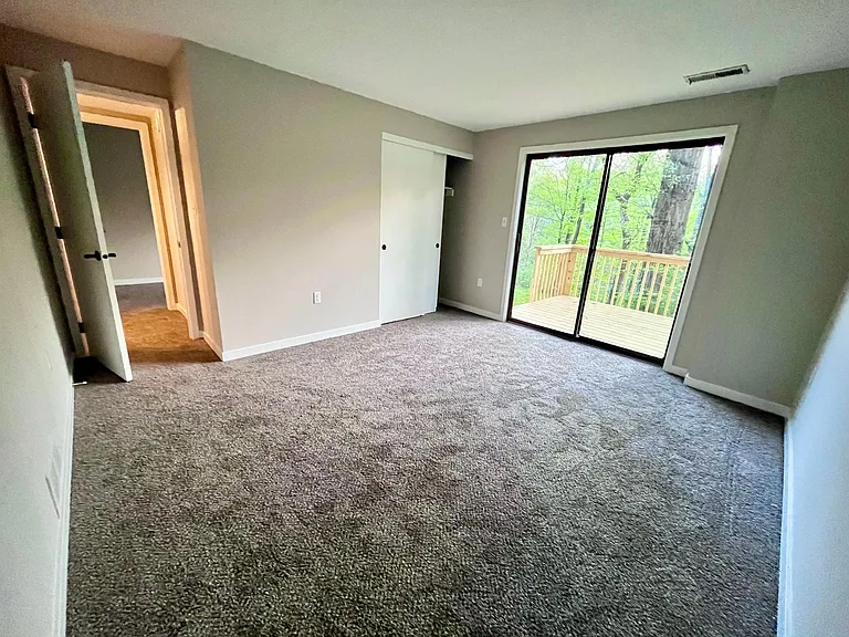 Lower level downstairs bedroom with walk out deck
