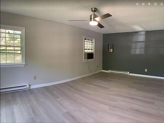 FAMILY ROOM has lots of windows and remote ceiling fan with multiple lighting options. Enjoy this lower level Family Room in the summer for its coolness.