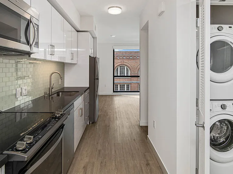 Kitchen with Stainless Steel Appliances and In-home Washer and Dryer