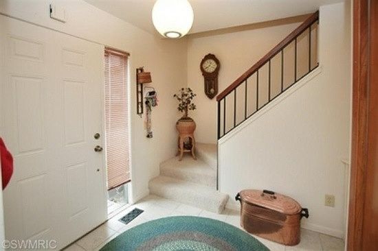 Enter to a tiled foyer that takes you straight back to the k