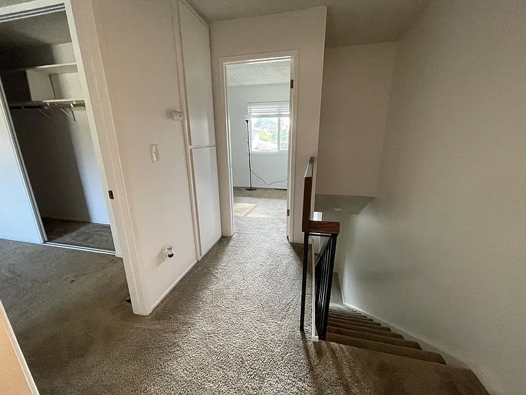 Upstairs hallway. Carpet has been replaced with laminate wood flooring.