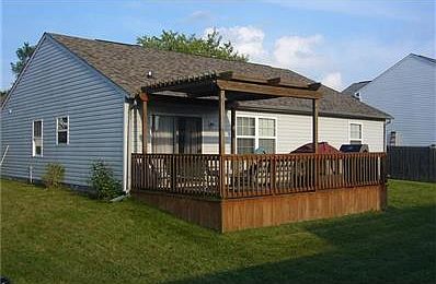 EXTERIOR BACK W/LARGE DECK AND NEWER ROOF