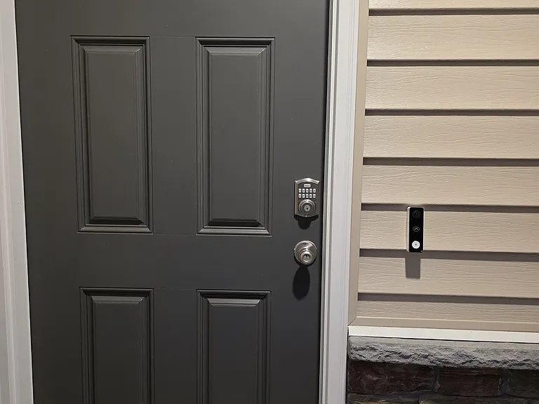 Front door with smart lock and video doorbell installed
