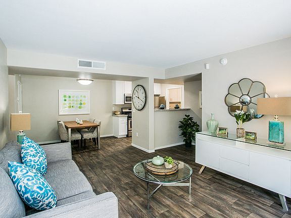 The living room at Aviara Apartment Homes features an open concept layout, fresh paint, and updated vinyl planking flooring, creating a modern and inviting space for residents to relax and entertain.