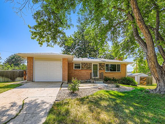 Exterior including 1-car attached garage. Fence access on the left and a "boat gate" on the right for access to the back yard.