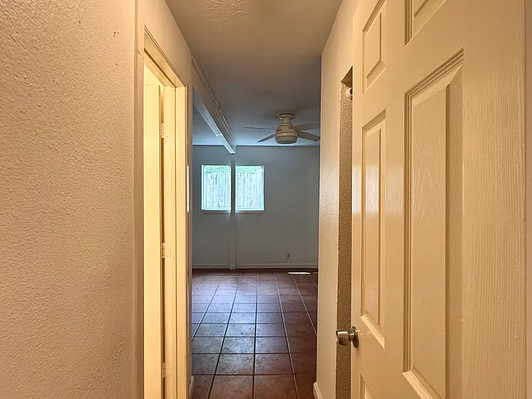 3rd bedroom: view from entryway off kitchen area. A small hallway with bathroom on L and closet on R leads into comfortably sized 3rd bedroom. A door to this hall and bedroom closes it completely off from the kitchen and dining area for total privacy.