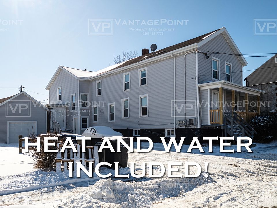 Exterior of large white and grey multi family home.