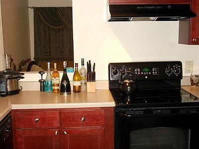Cherry cabinets and newer appliances in the kitchen.