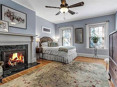 bedroom suite with queen size bed, full bath with tiled walk-in shower and windows overlooking back deck and back yard