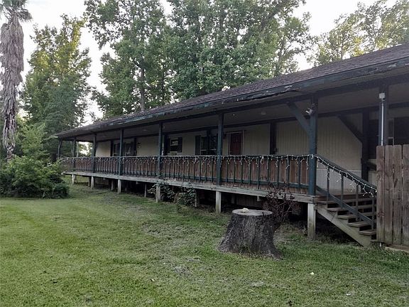 Large front porch with electricity and lights attached to  the ceiling.