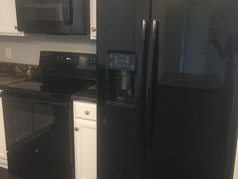 Brand new side-by-side GE fridge, stove and microwave