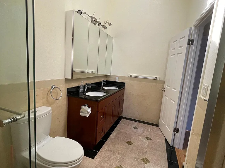 master bathroom with medicine cabinet and 2 sinks