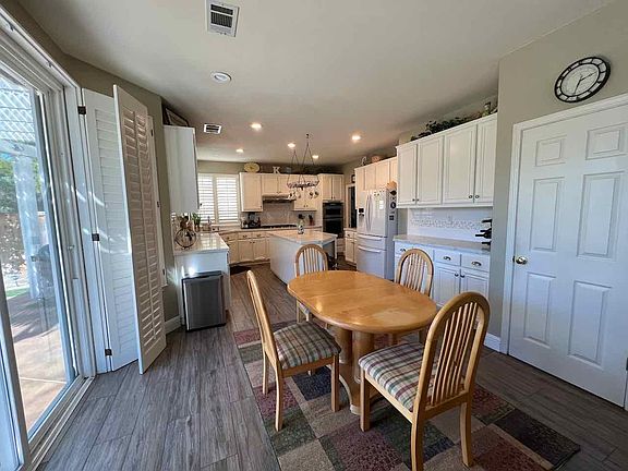 Huge kitchen, Large island, White cabinets, White quartz countertops