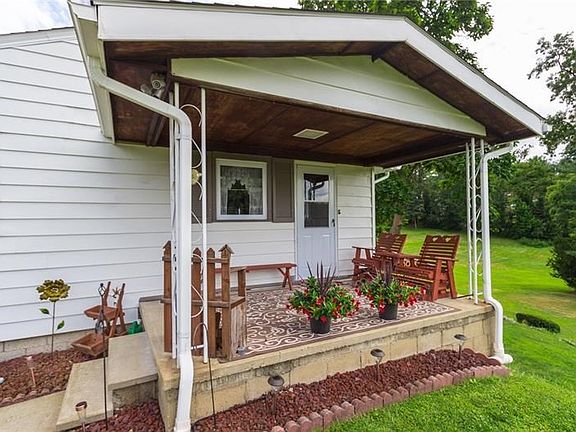 Welcoming Side Porch is a nice sitting area to enjoy the view