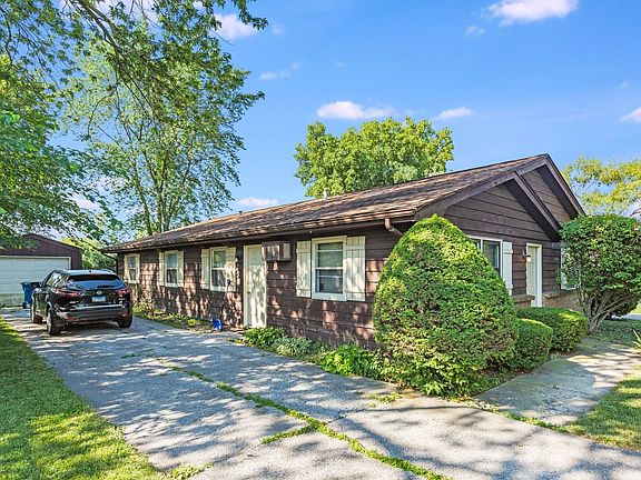 Exterior 1445 Side with long Driveway and a Garage.