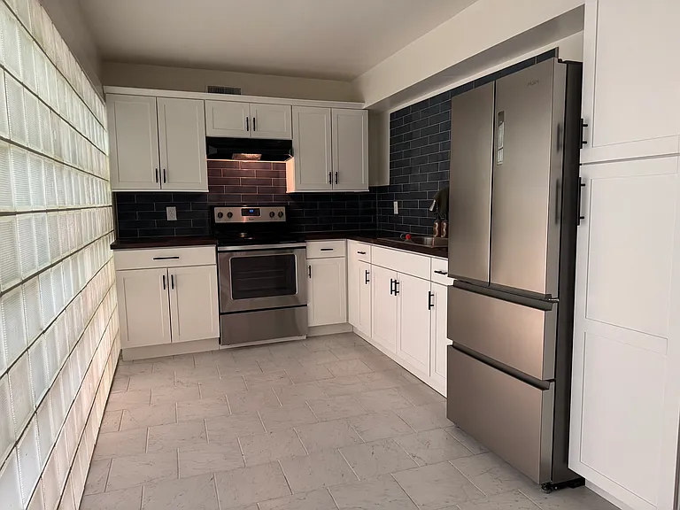 Kitchen w/ new fridge.