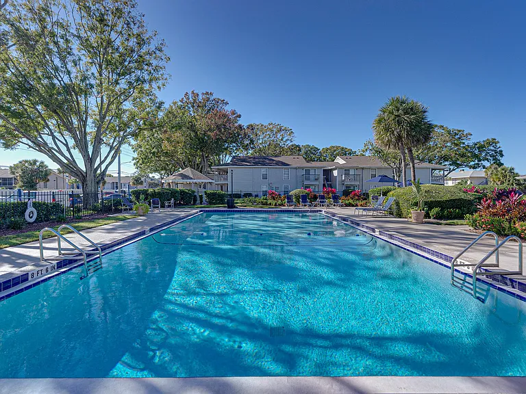 Enjoy a refreshing swim in our large community pool surrounded by lush landscaping and comfortable lounge seating.