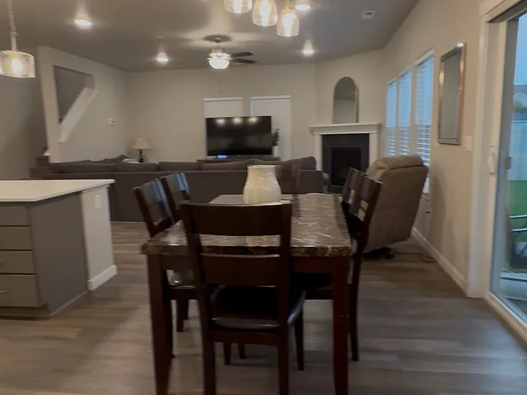 Open-concept living and dining space overlooking the great room with fireplace.