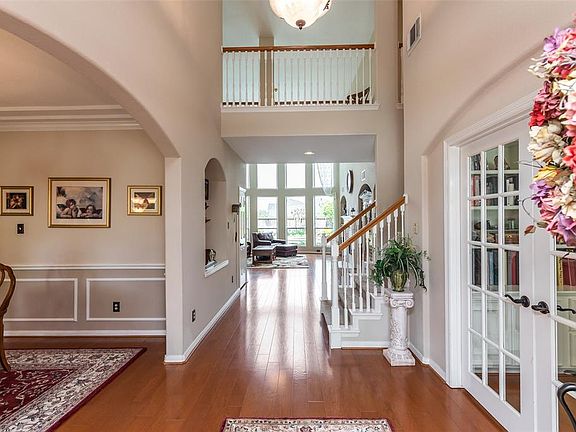 A 2-story entry and upstairs balcony is your first view. The hardwood flooring extends through the foyer, study, dining room & family room beyond.