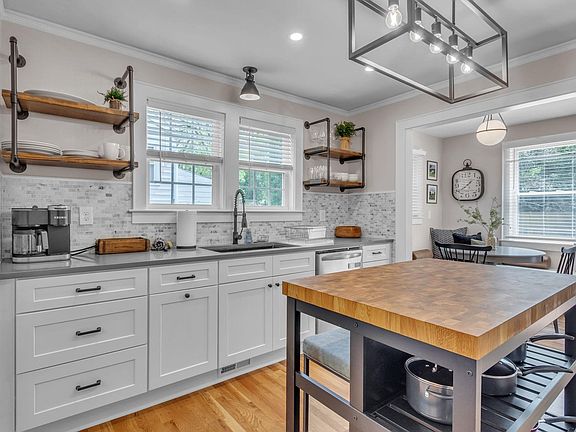 The kitchen is modern and equipped with all you need for cooking and baking. Stainless steel appliances, a Keurig, and an island for extra preparation space truly set it apart.