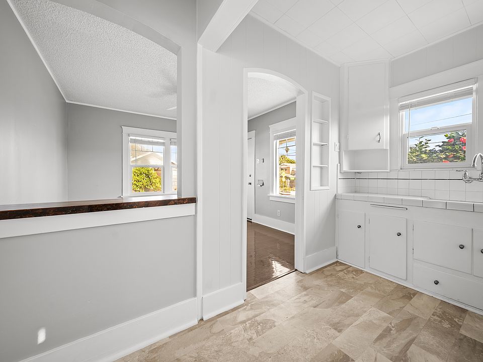 standing in the kitchen looking toward the living room ... open but separate