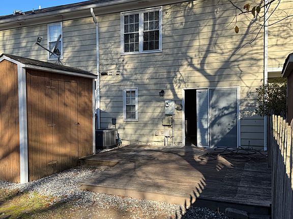 Back of house with shed and deck.
